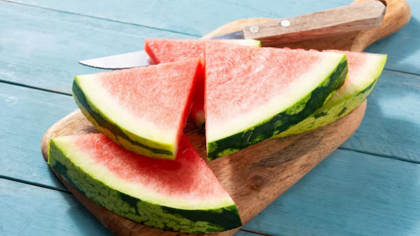 Fresh watermelon slices on wooden cutting board