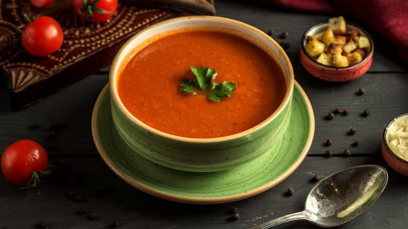 Bowl of Tomato Soup with Garnish and Sides