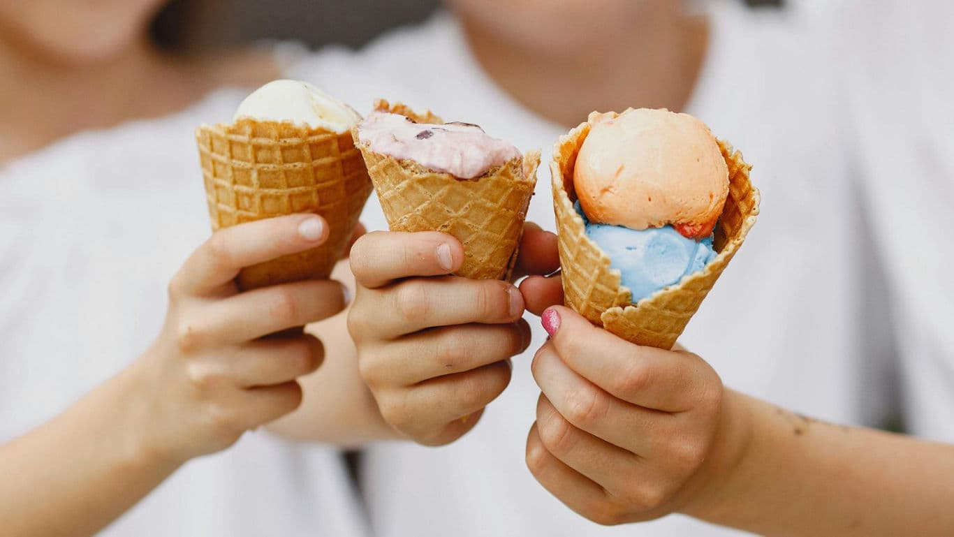 Children holding colorful ice cream cones
