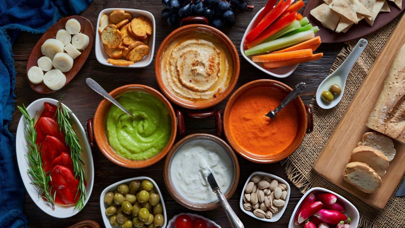 A spread of dips with sides
