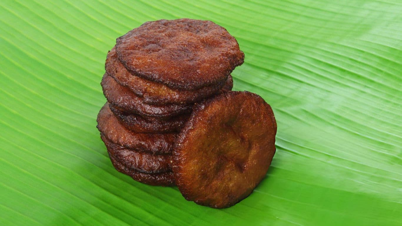 Stack of fried snacks on banana leaf