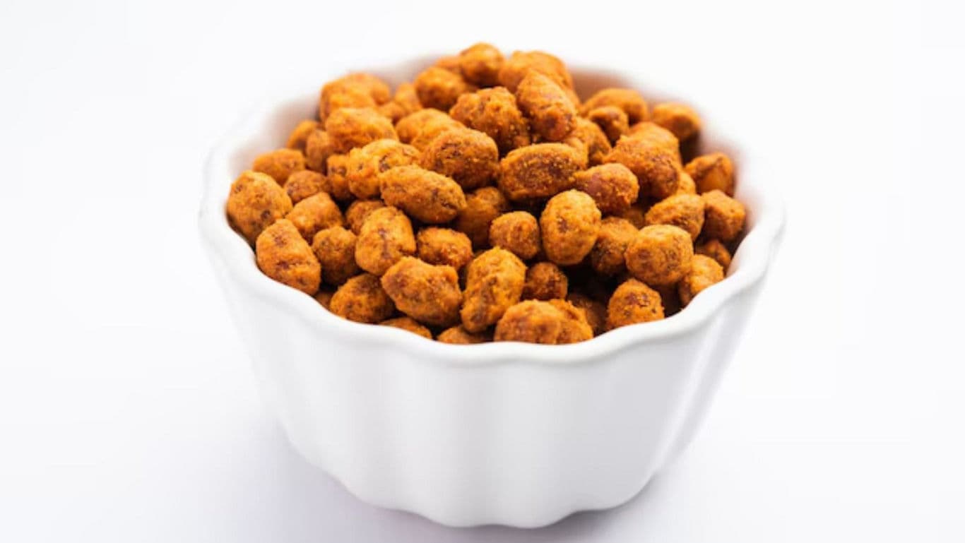 Spicy roasted peanuts in white bowl