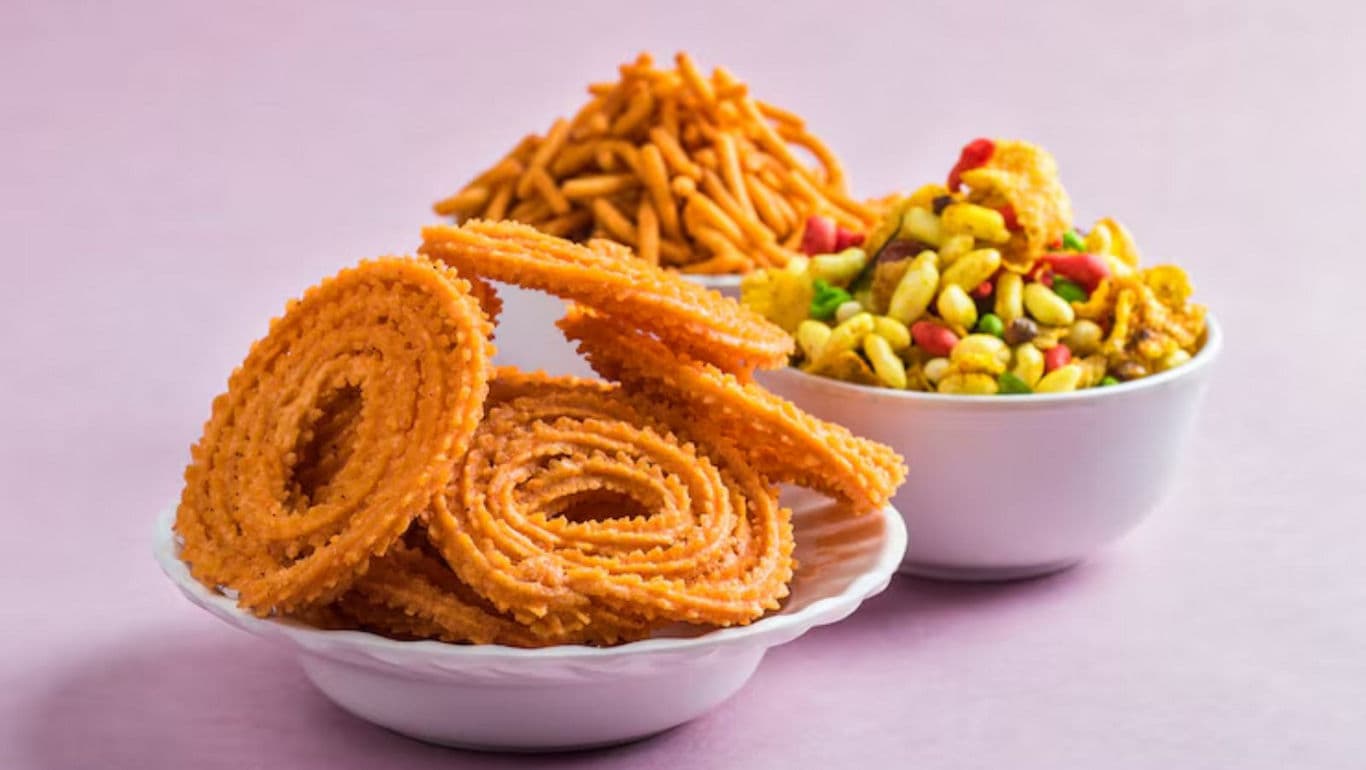 Indian savory snacks on pastel background