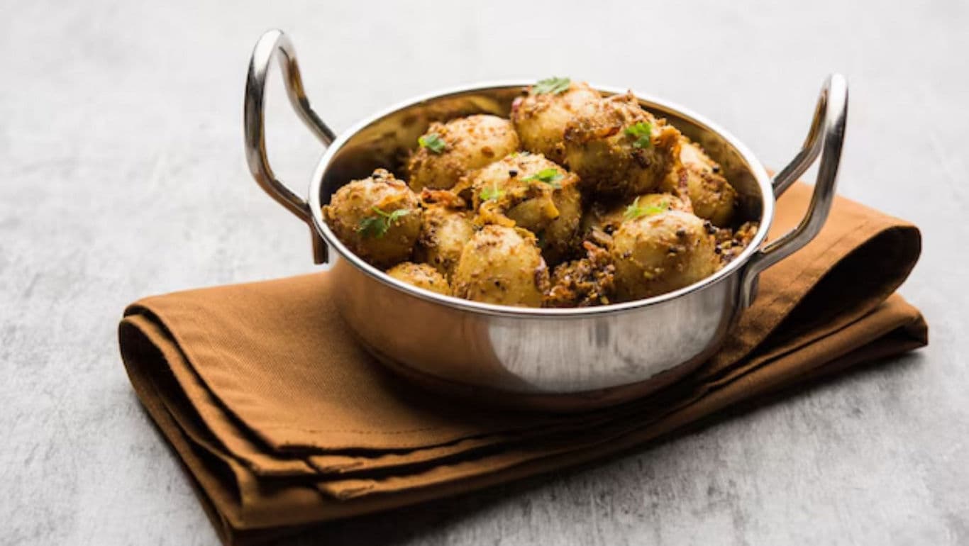 Spiced baby potatoes in a steel bowl