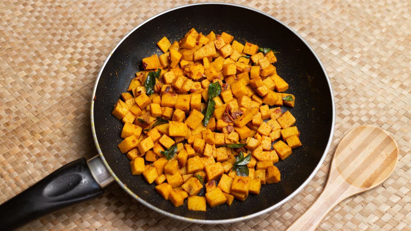 Pan-fried spiced sweet potatoes on woven mat