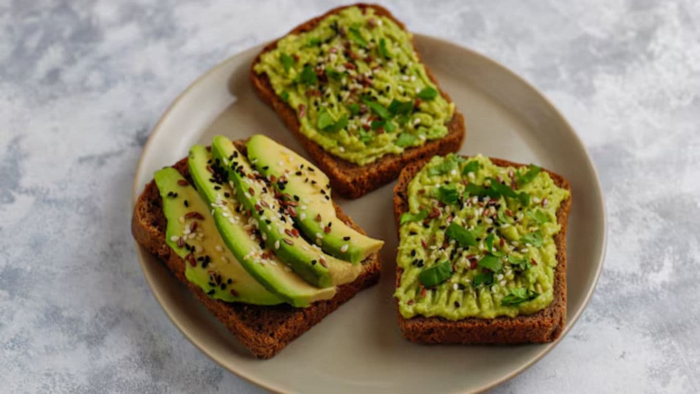 Avocado toast with sesame seeds on plate