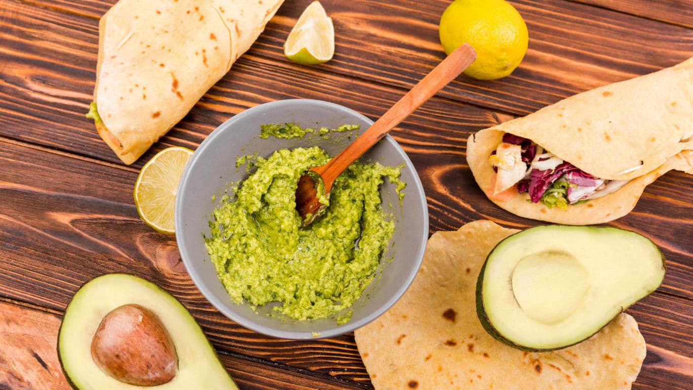 Fresh guacamole with tortillas and avocado