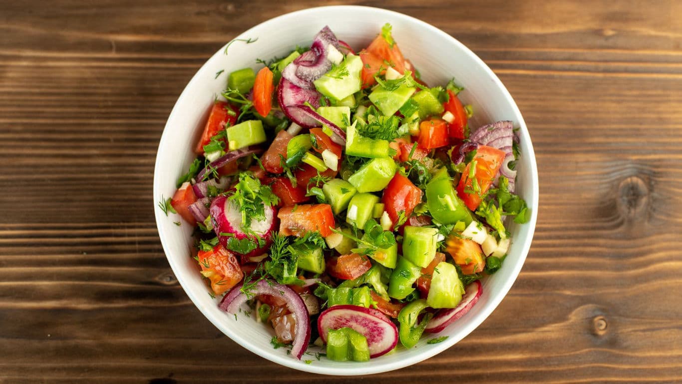 Fresh vegetable salad in white bowl