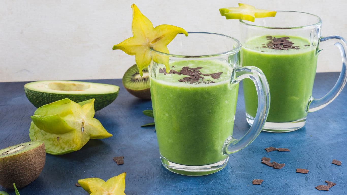 Green smoothie with starfruit garnish