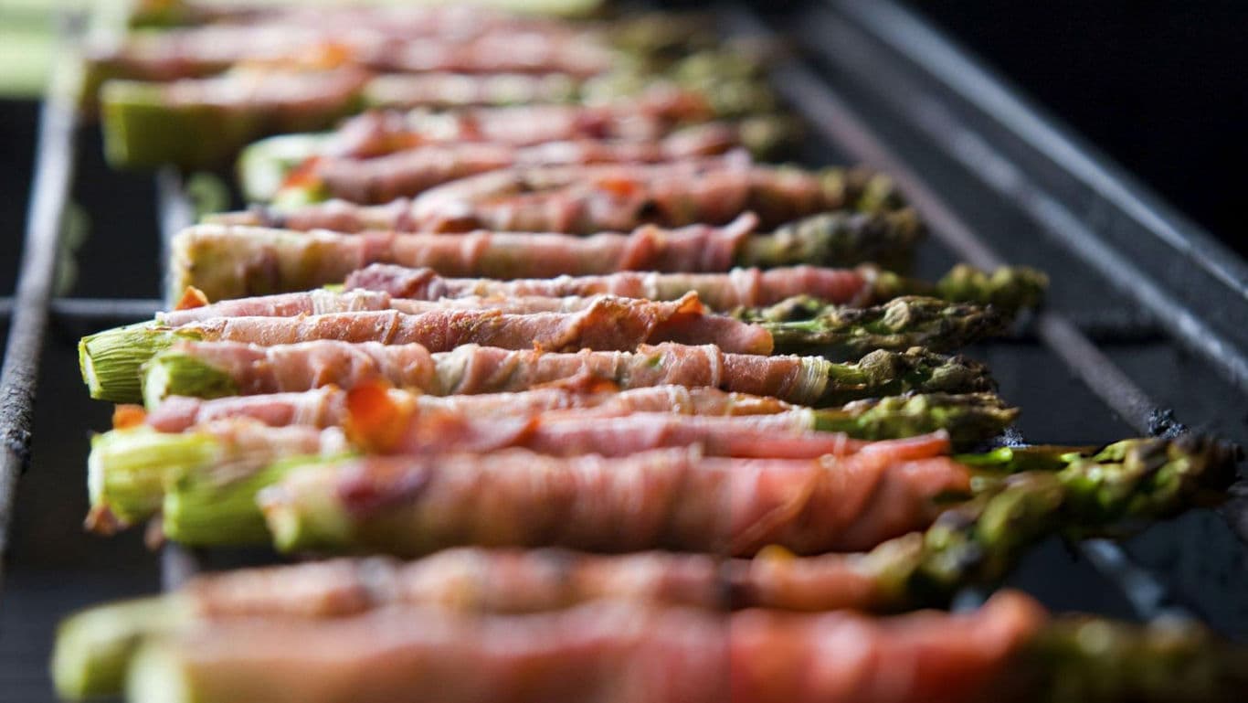 Grilled bacon-wrapped asparagus on barbecue