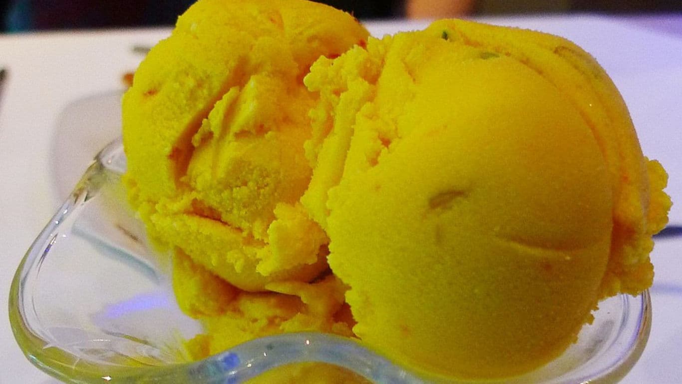 Bright yellow ice cream scoops in bowl