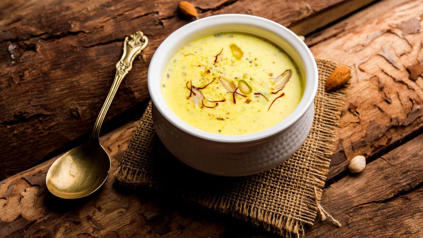 Creamy saffron dessert in white bowl