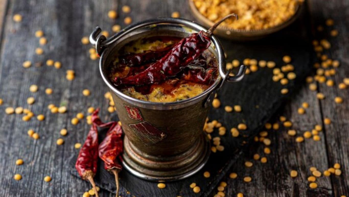 Spicy Indian dal served in rustic metal bucket