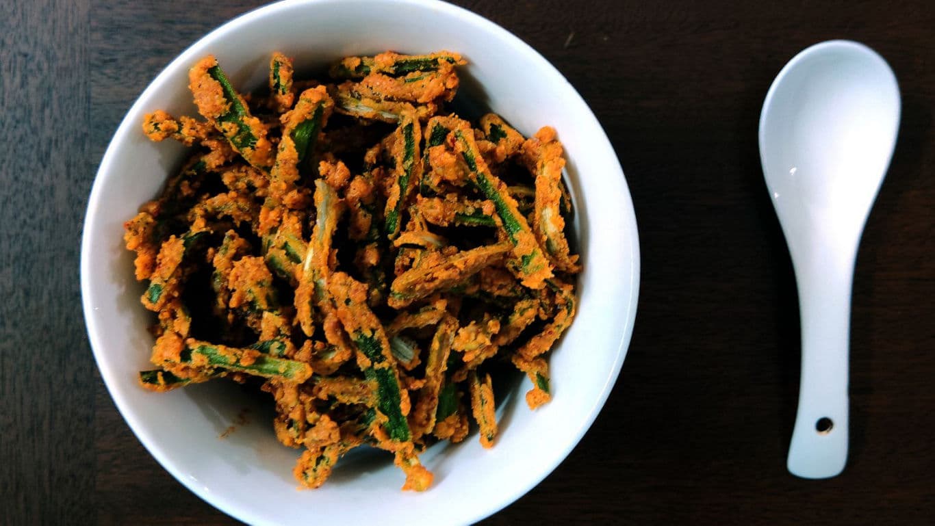 Crispy okra in white bowl with spoon