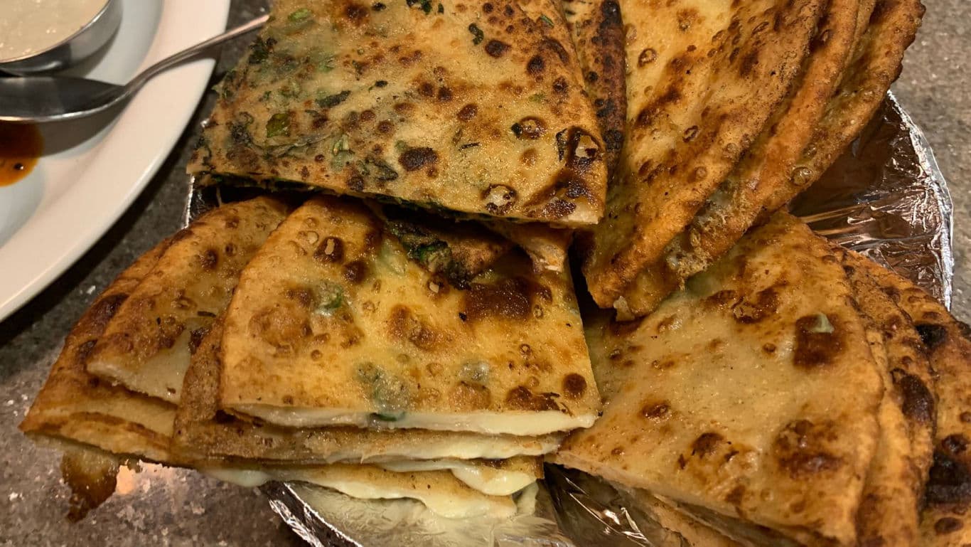 Stacked stuffed flatbreads with dipping sauces