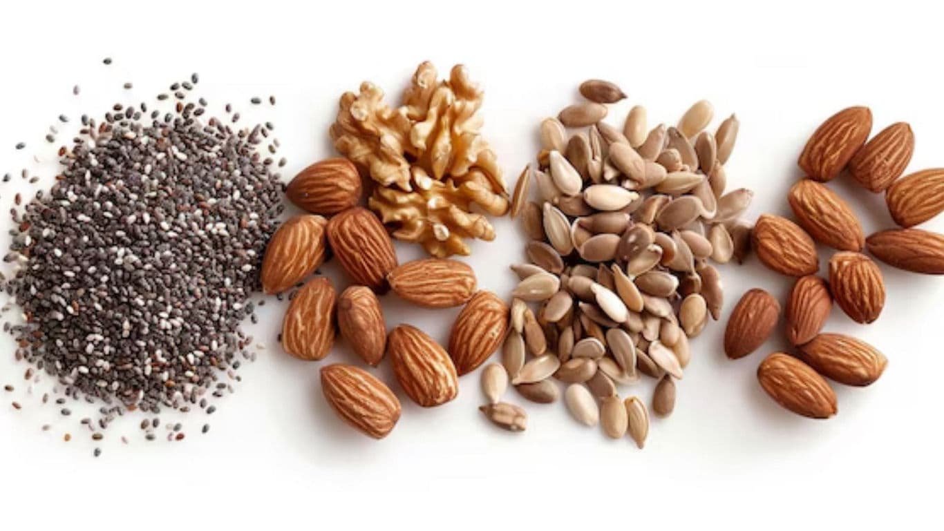 Assorted nuts and seeds on white background