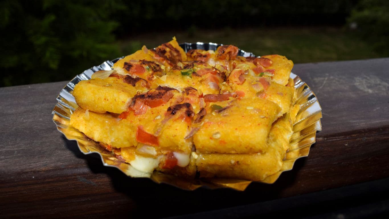 Crispy fried snack with toppings outdoors