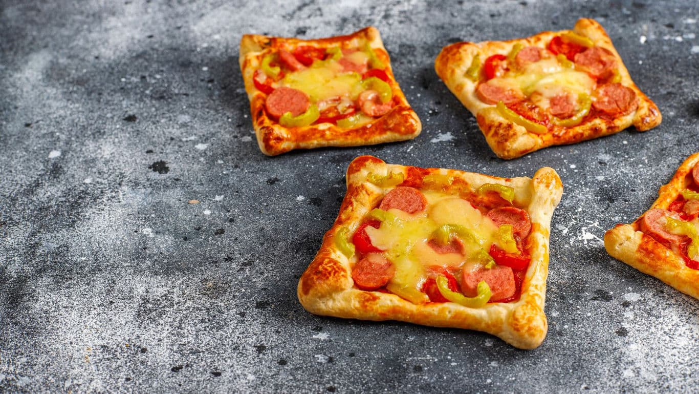 Mini square pizzas with sausage and cheese