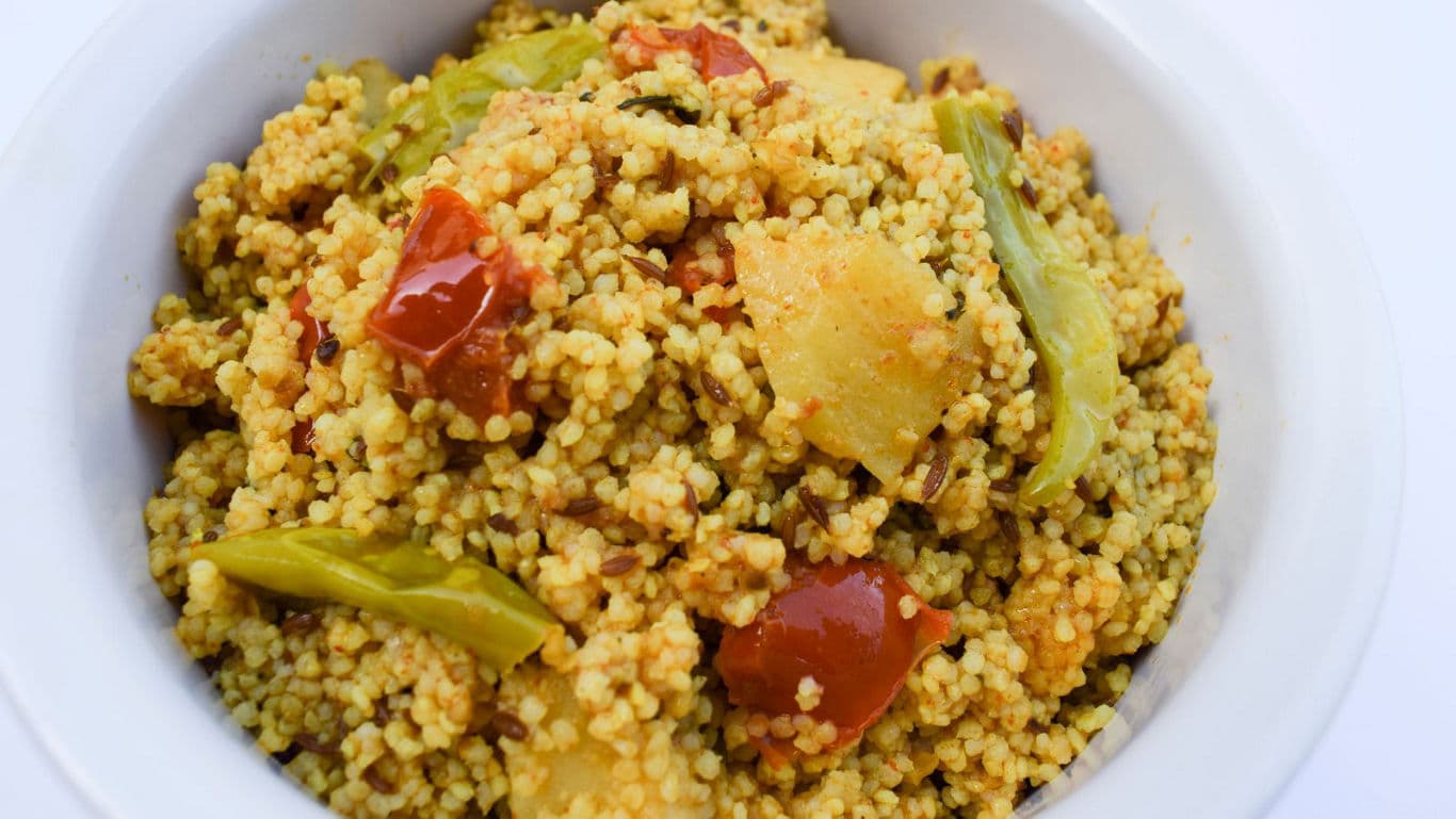 Bowl of spiced couscous with vegetables