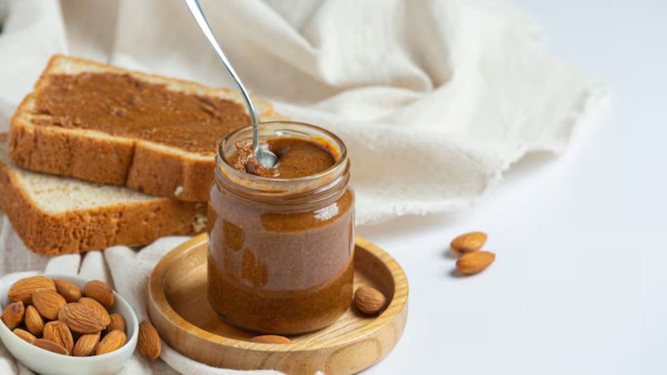 Jar of almond butter with bread slices