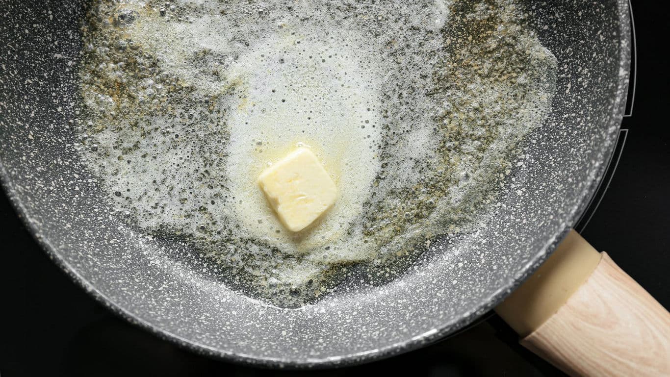 Butter melting in non-stick frying pan