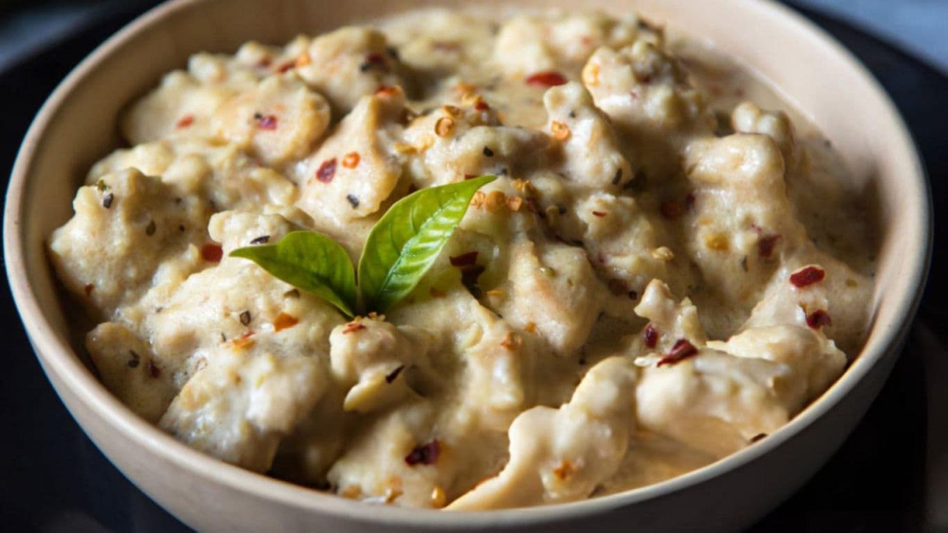 Creamy white pasta with basil garnish