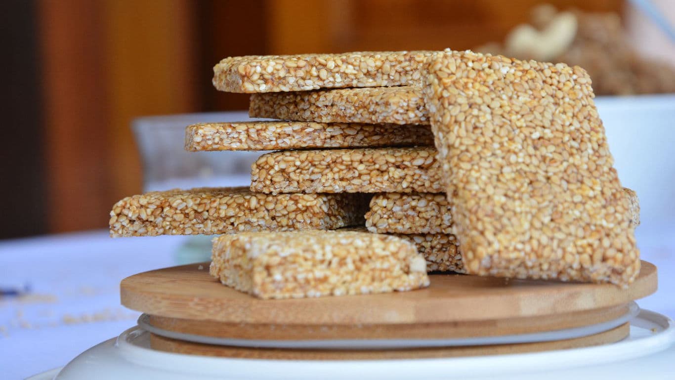 Stacked sesame seed brittle on wooden plate