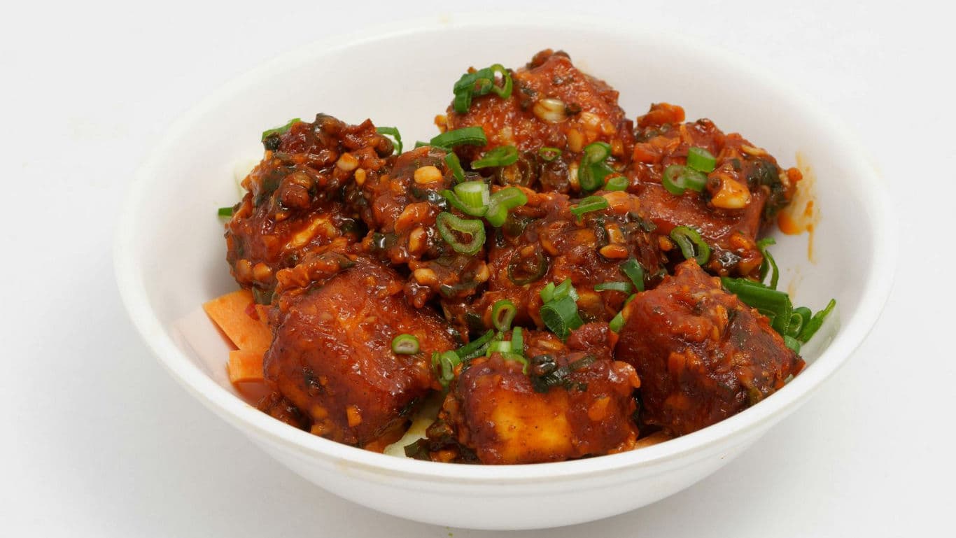 Spicy paneer dish in white bowl
