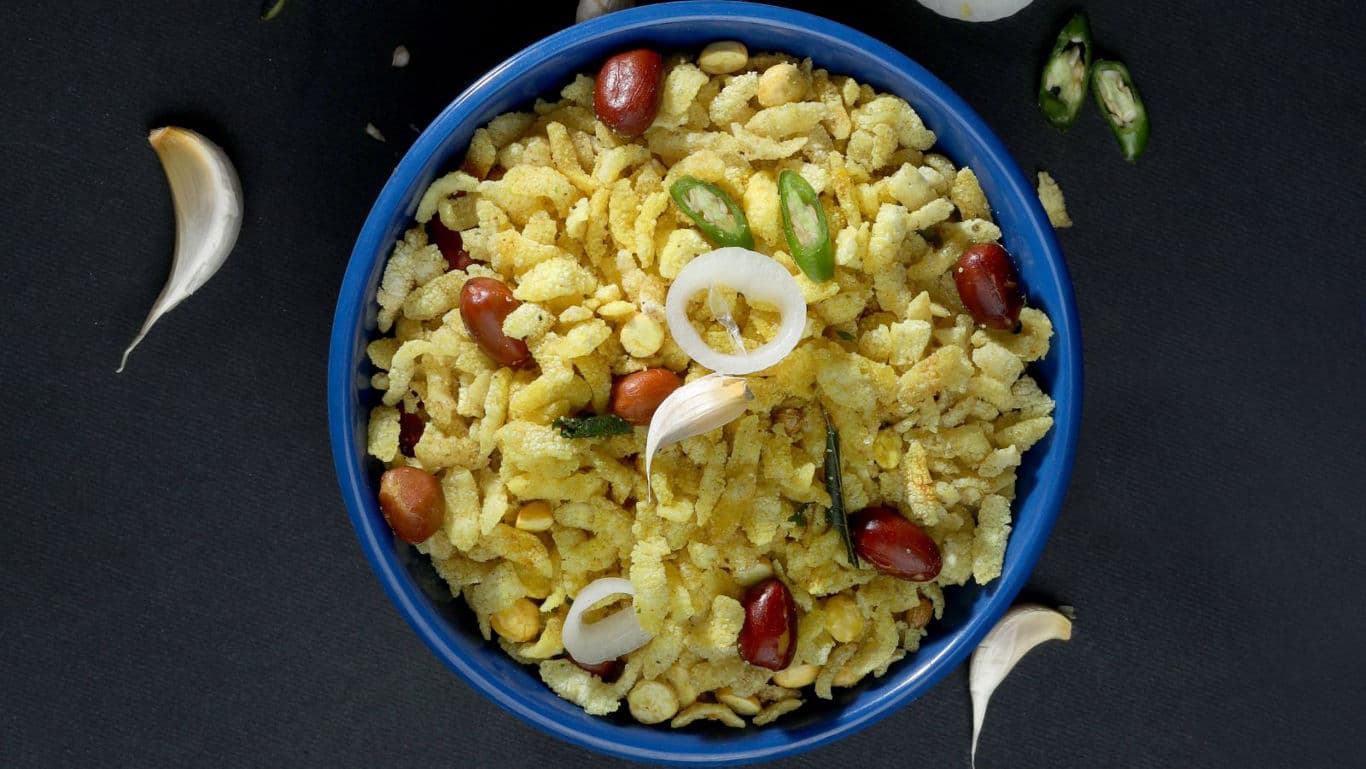Spicy puffed rice snack in blue bowl