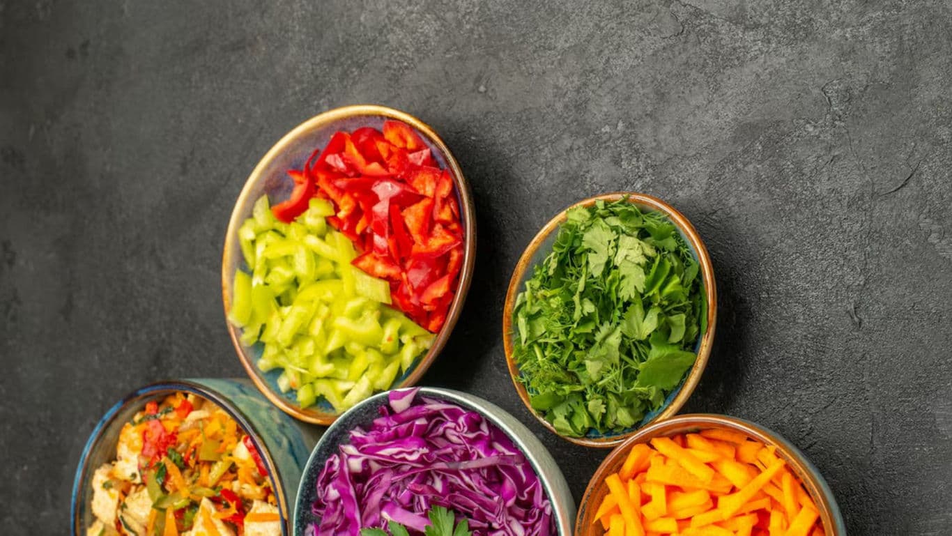 Colorful bowls of fresh chopped vegetables