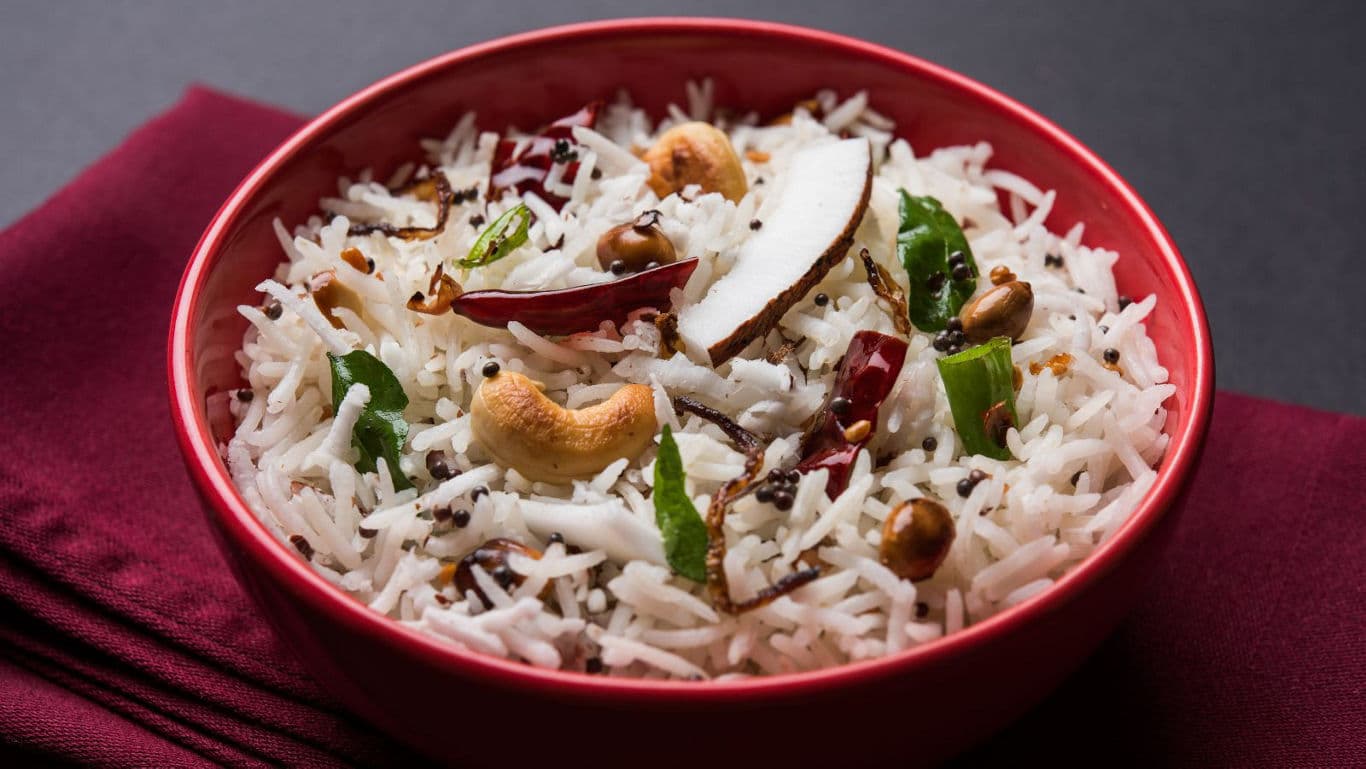 Coconut rice in red bowl with spices