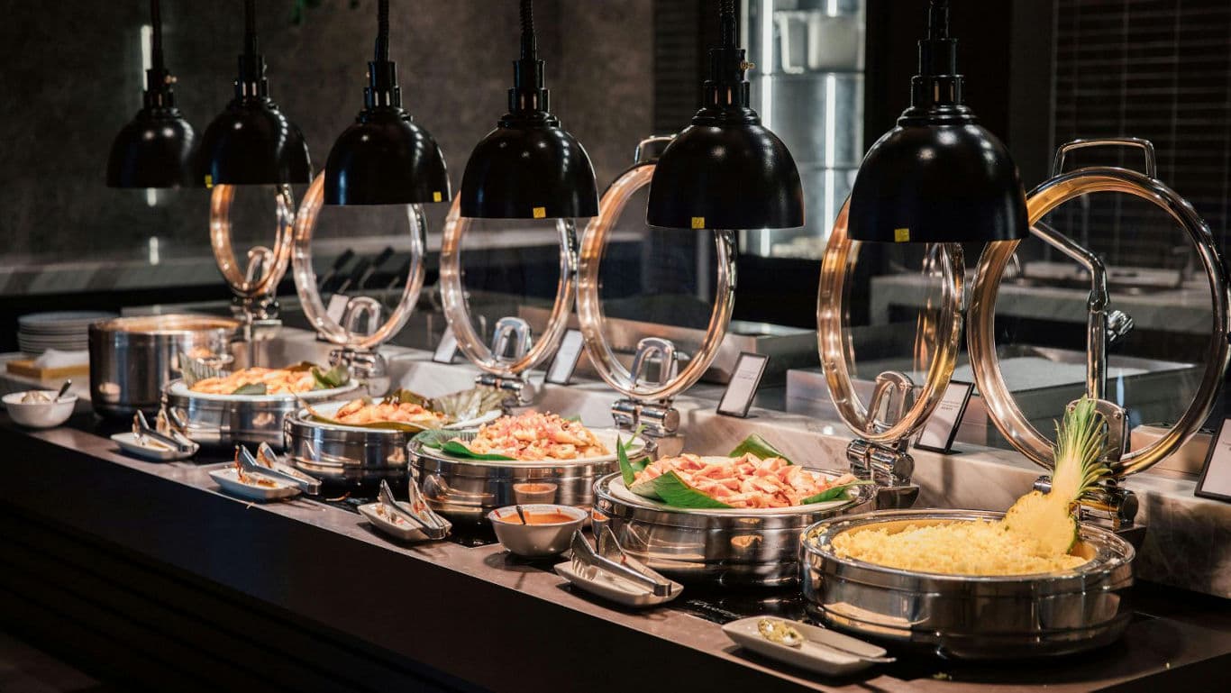 Elegant buffet spread under black pendant lamps