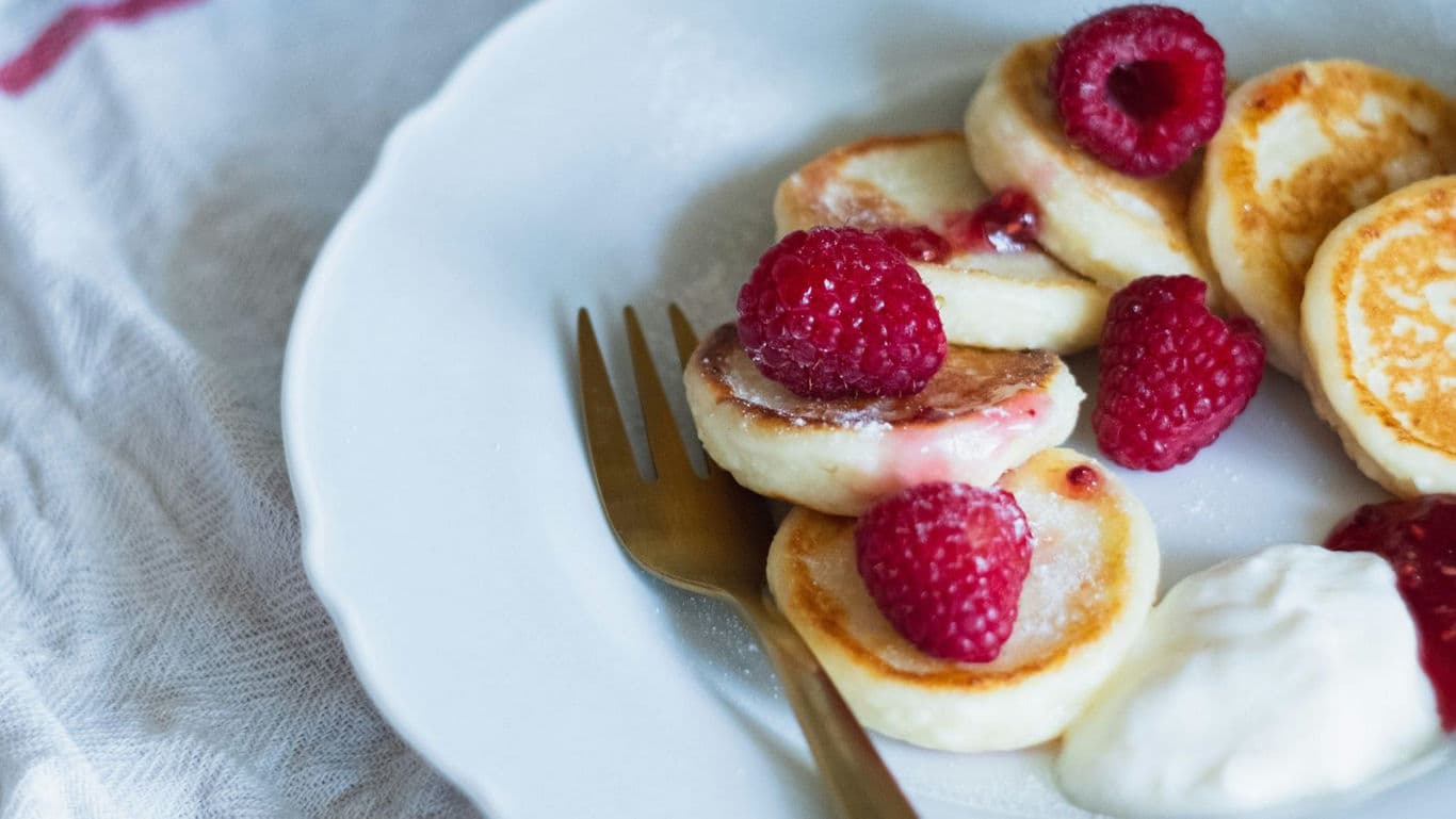 Fluffy pancakes with raspberries and cream