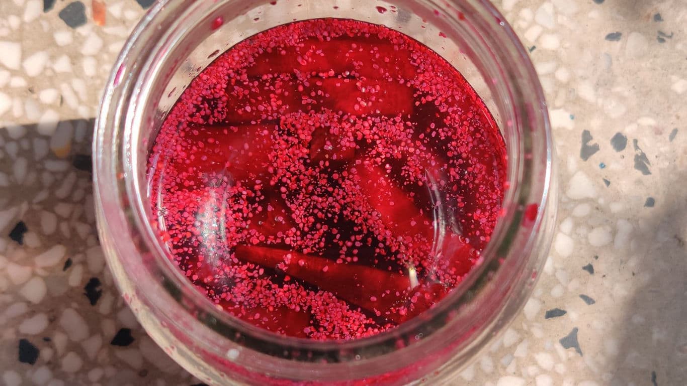 Top view of jar with red pickled vegetables