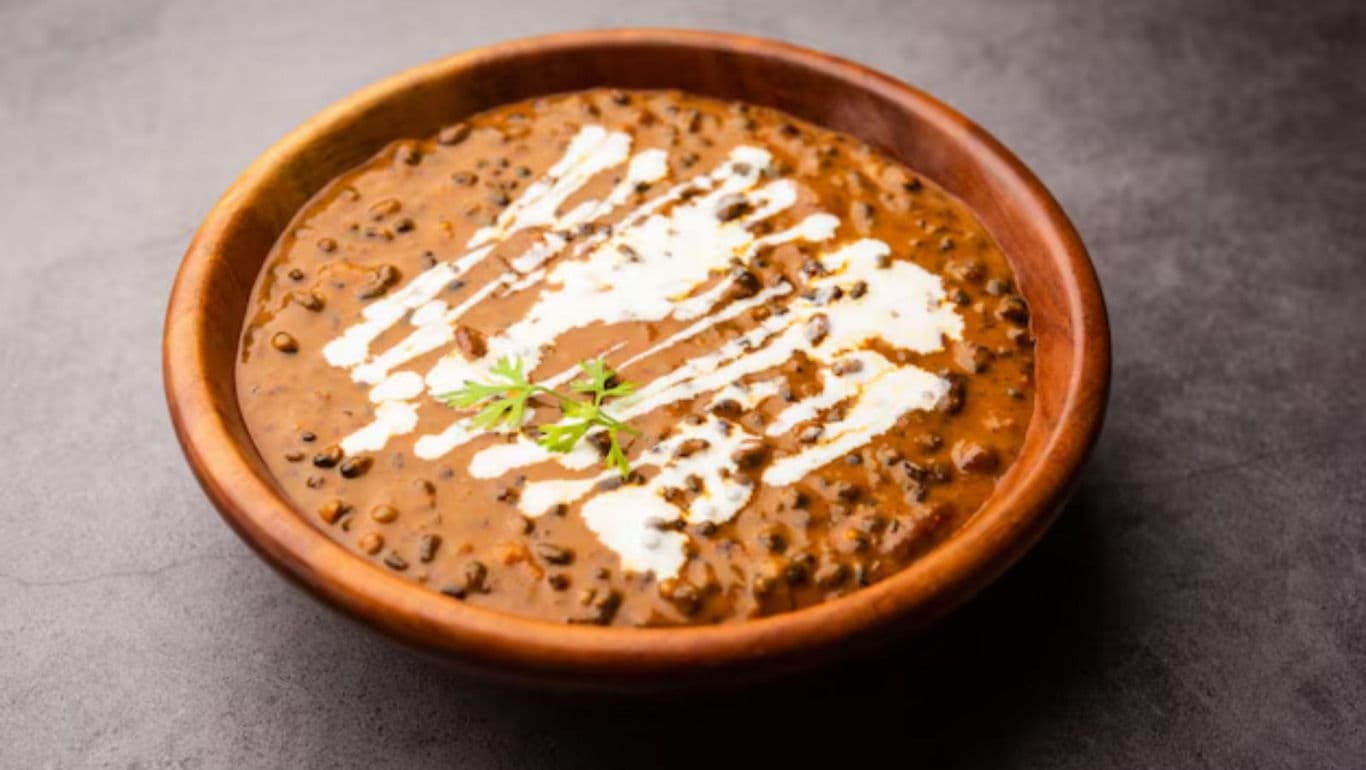 Creamy lentil curry in wooden bowl
