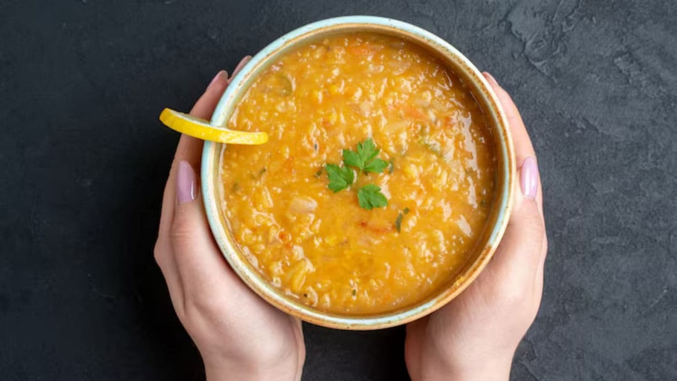 Bowl of Lentil Soup with Lemon Garnish