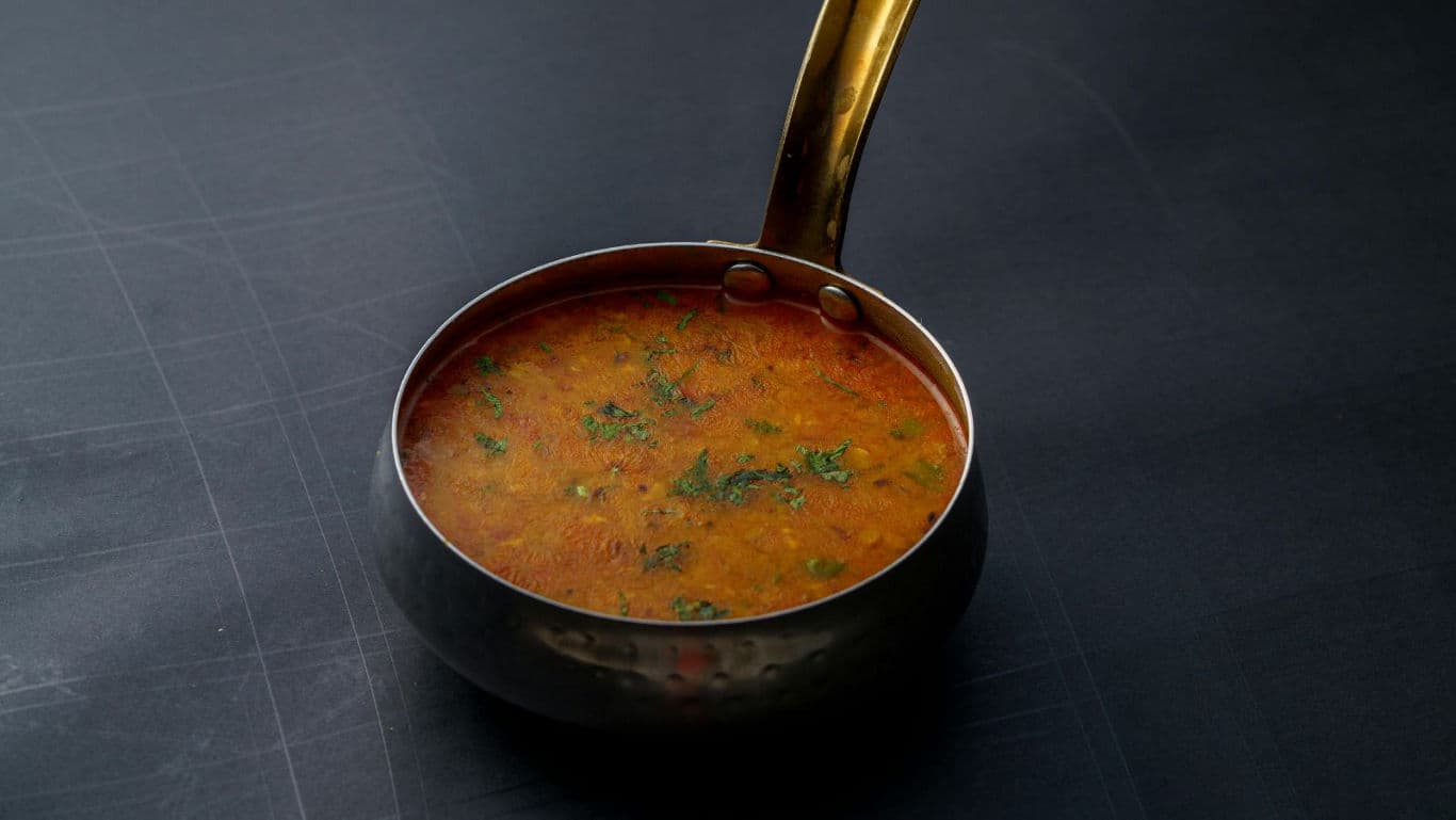 Golden saucepan with vibrant soup