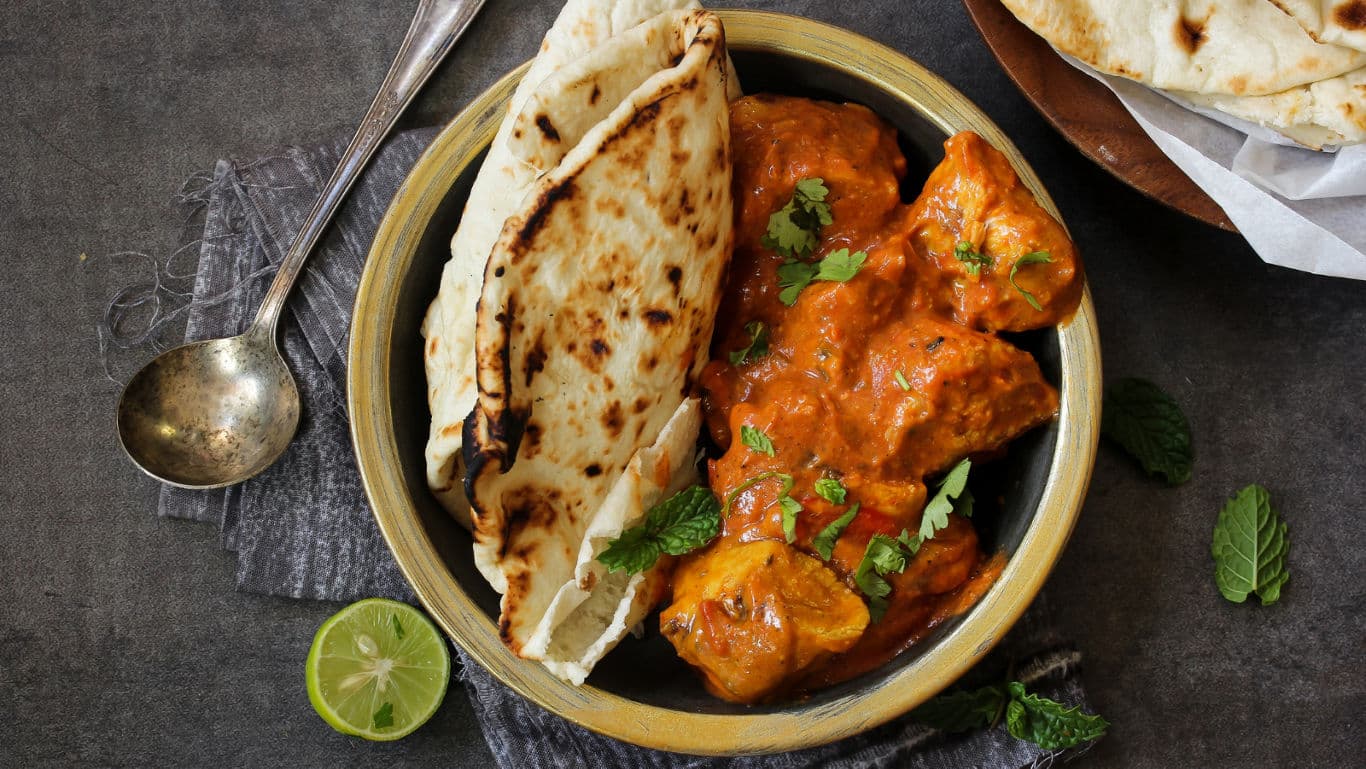 Indian curry with naan bread and lime