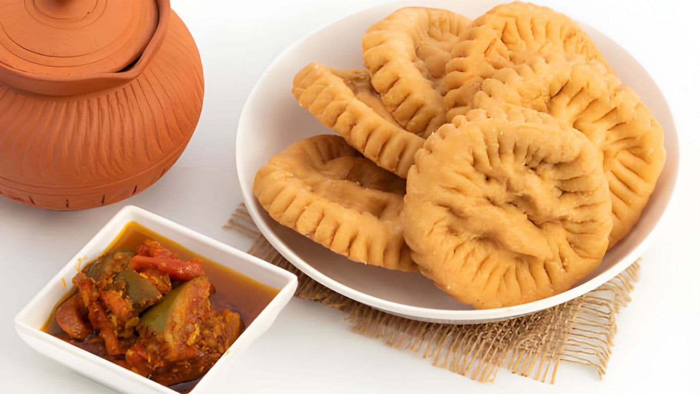 Traditional fried pastries with spicy stew
