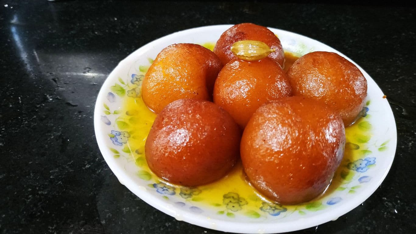 Plate of sweet gulab jamun dessert