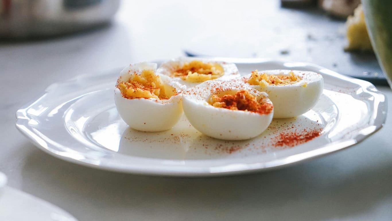 Deviled eggs served on white ceramic plate