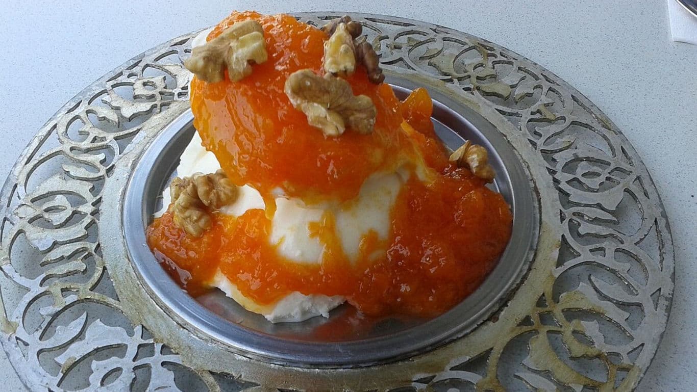 Dessert with walnuts and orange topping