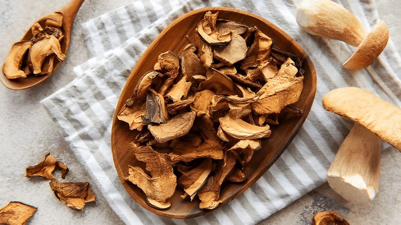 Dried porcini mushrooms ready for powdering on a plate