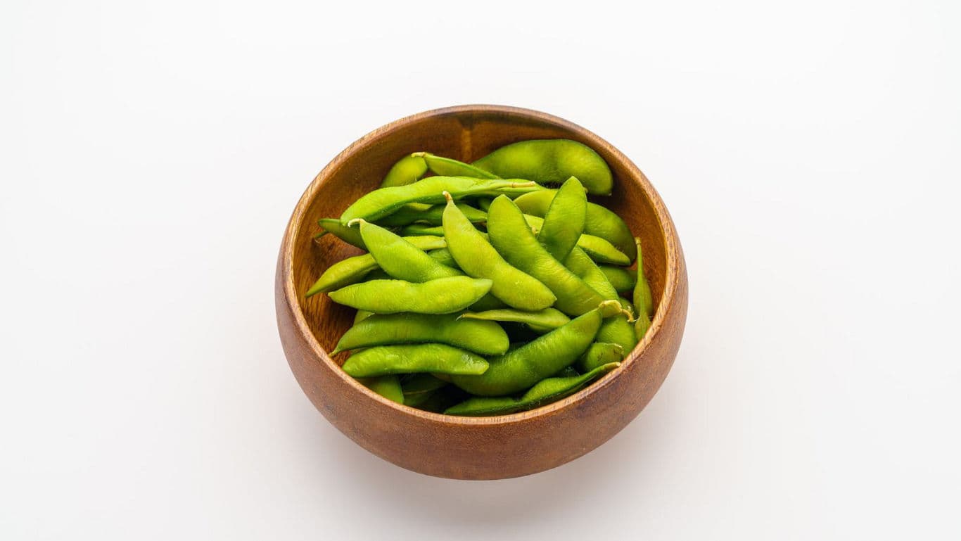 Wooden bowl of fresh green edamame
