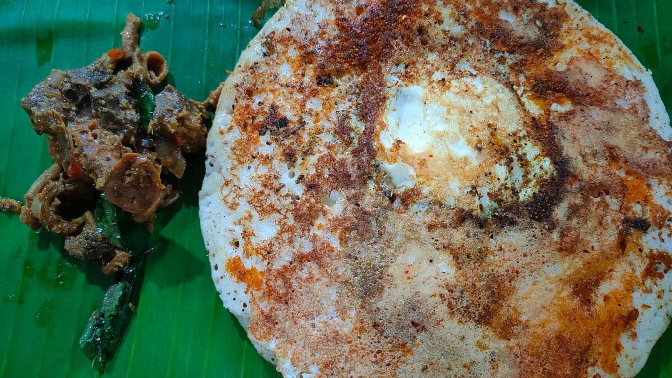 Spicy dosa with curry on banana leaf