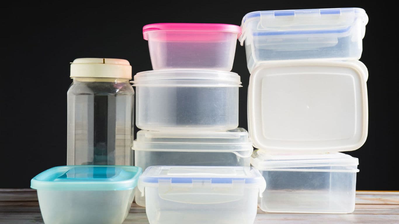 Stacked plastic food containers on wooden table