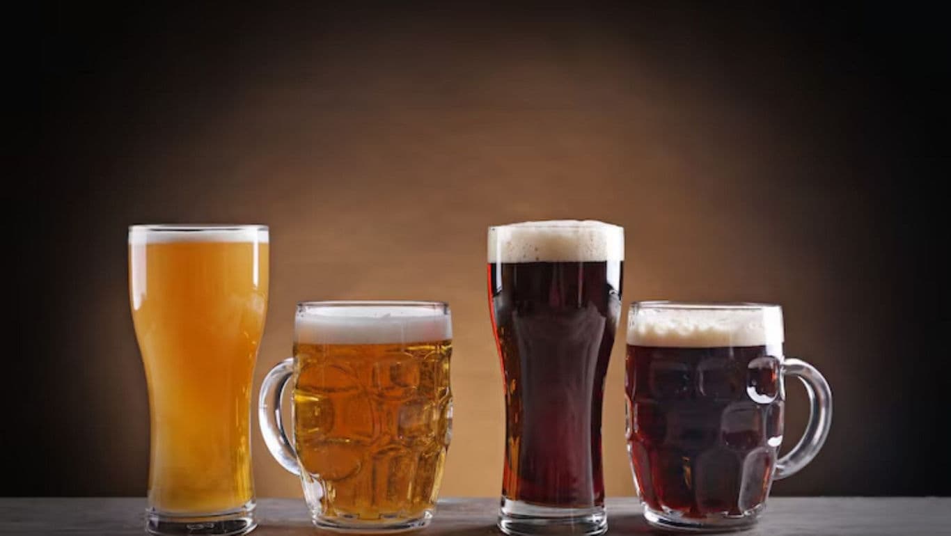 Four beer glasses with different types of beer