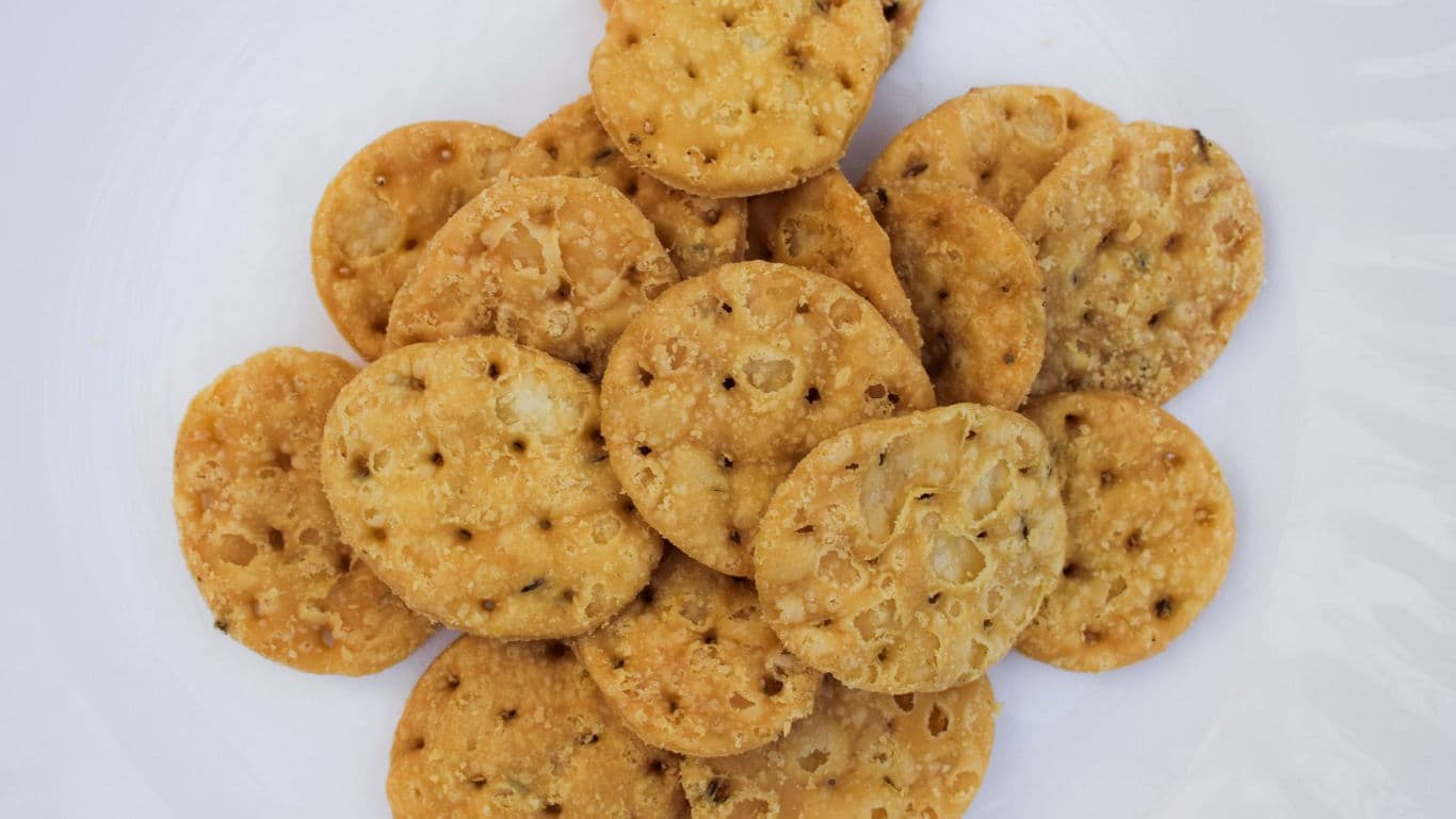 Crispy round crackers on white plate