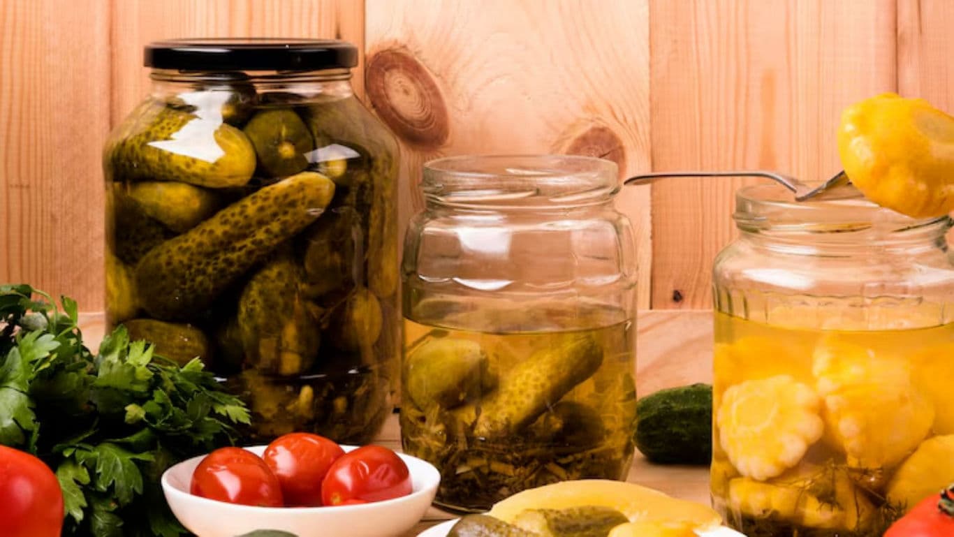 Assorted Pickled Vegetables in Glass Jars on Table