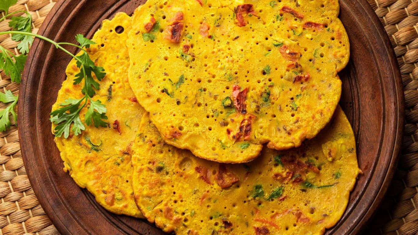 Golden savory pancakes on wooden plate